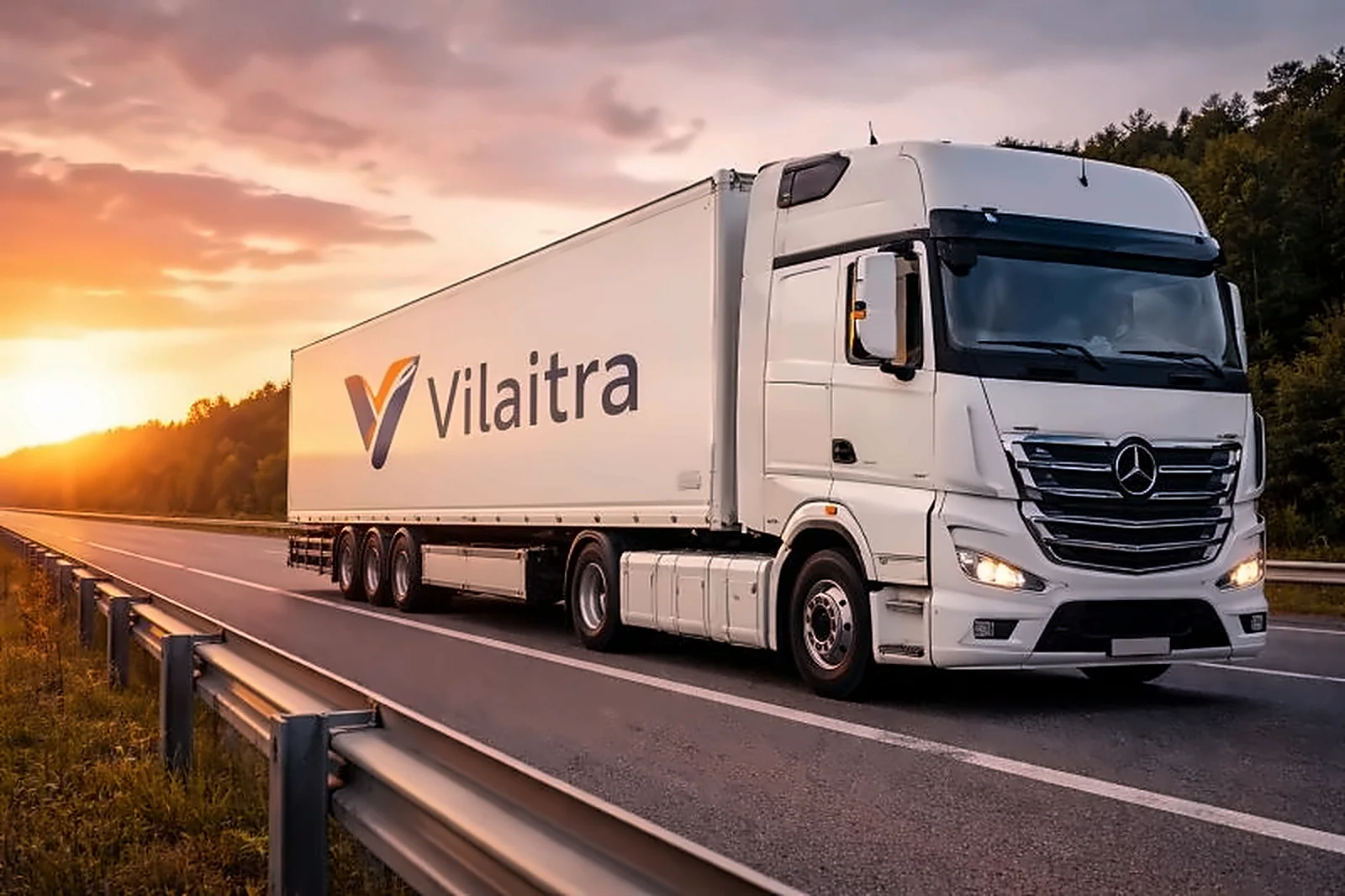 Белый тягач Vilaitra с полуприцепом на трассе на закате